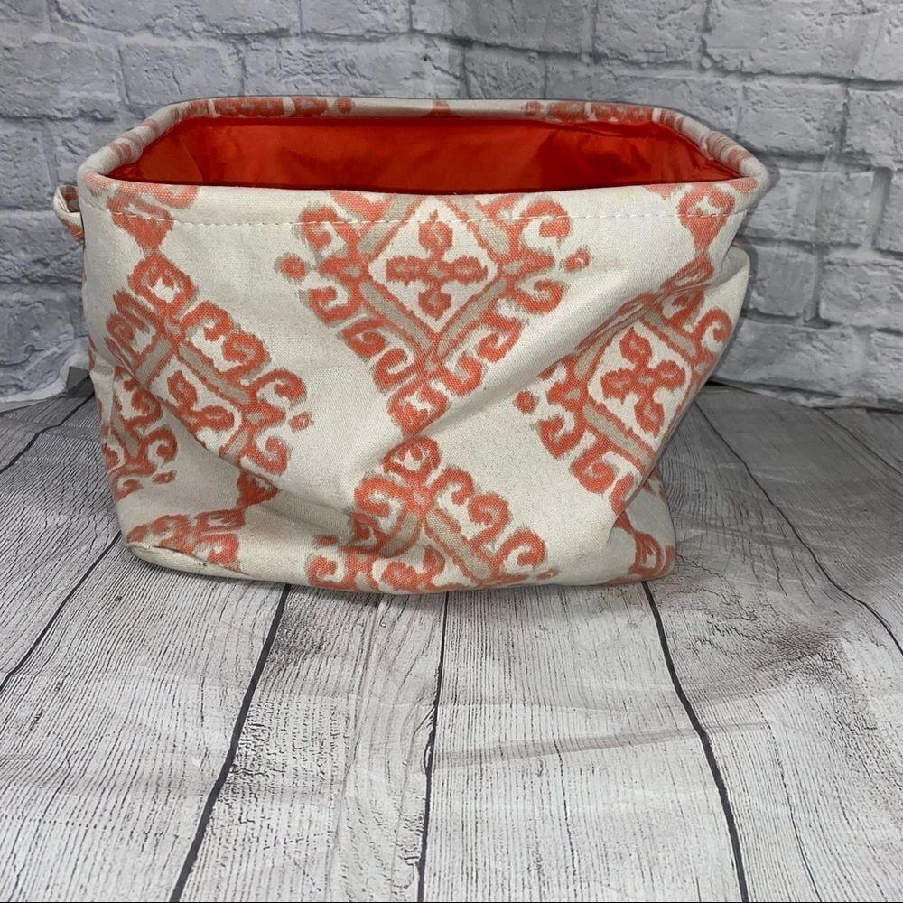 Collapsible print canvas covered storage cube with metal rim and side handles